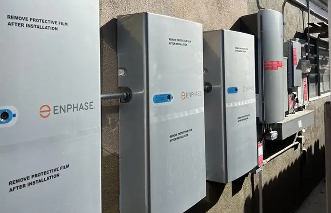 Several Solar Panel Installations on a Wall with Connecting Equipment