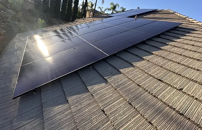 Solar Panels Installed on Tiled Roof in Sunny Weather