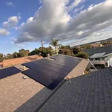 Solar Panels Installed on Rooftop Under Partly Cloudy Sky